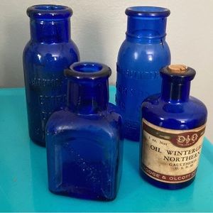 Lot of four vintage apothecary bottles.